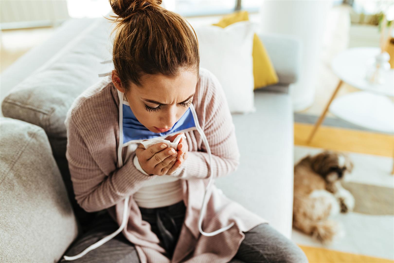 young-woman-using-paper-tissue-coughing-while-being-home.jpg