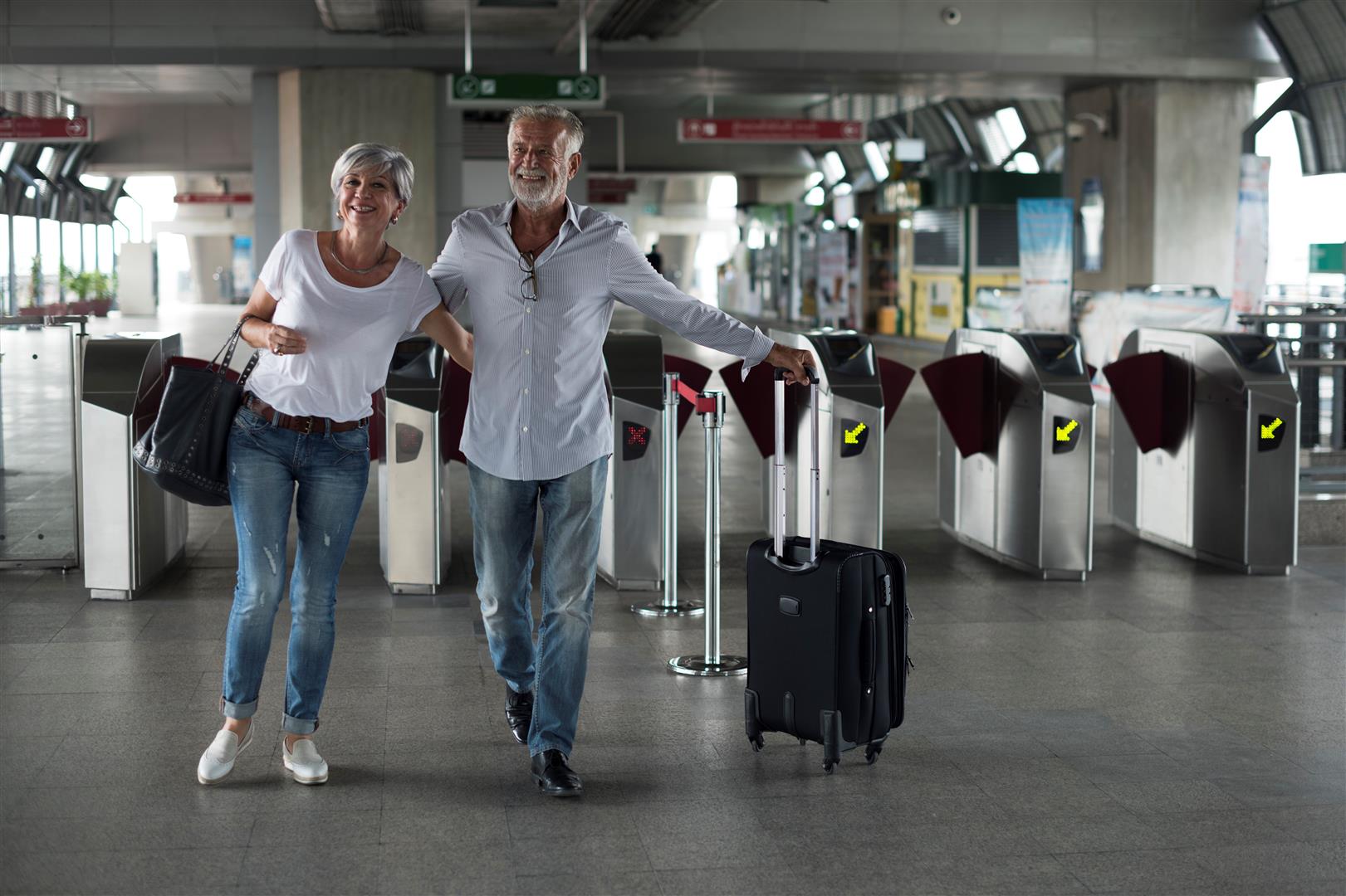 senior-couple-traveling-train-ticket-gate.jpg