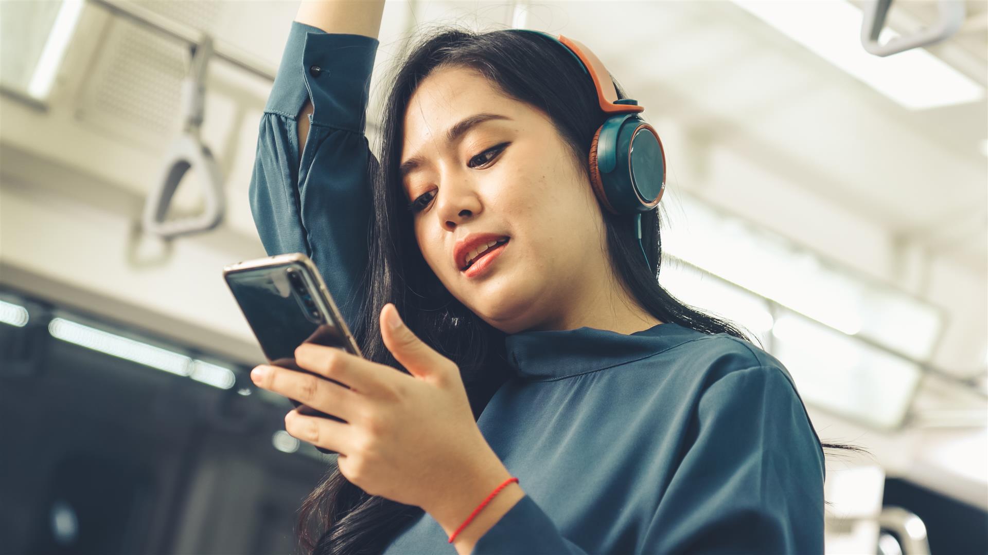 young-woman-mobile-phone-public-train.jpg