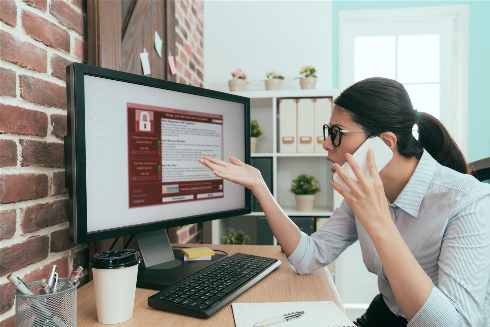 professional-business-woman-using-mobile-smart-phone-calling-help-when-her-company-working-computer-getting-virus-invasion.jpg